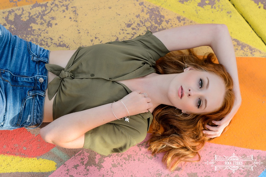 Denver senior photo of girl laying down with red hair. 