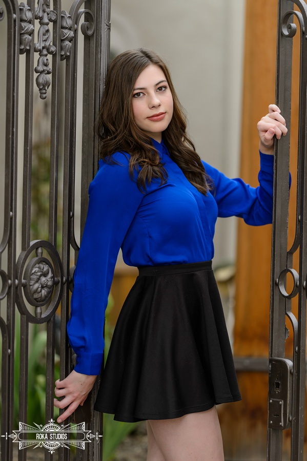 Denver senior photos of a girl in black skirt and blue top. 