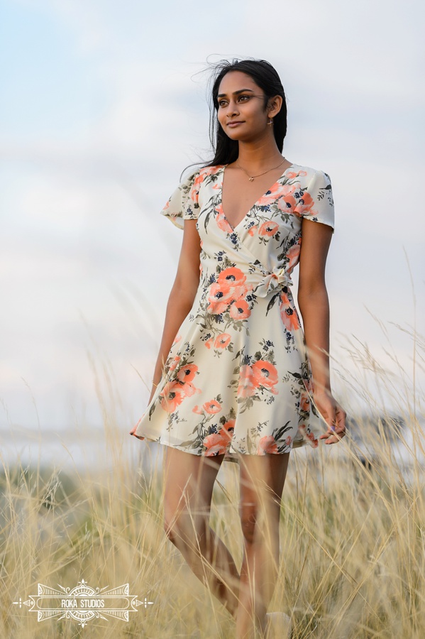 senior girl in floral dress looking into the distance